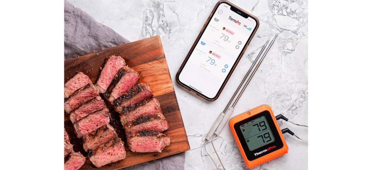 ThermoPro Wireless Meat Thermometer next to phone and cooked meat