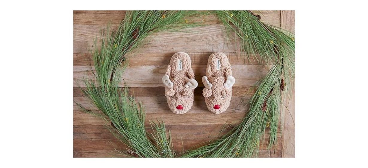 a pair of fuzzy slippers that have antlers and a red nose to make them look like reindeer heads a pair of fuzzy slippers that have antlers and a red nose to make them look like reindeer heads