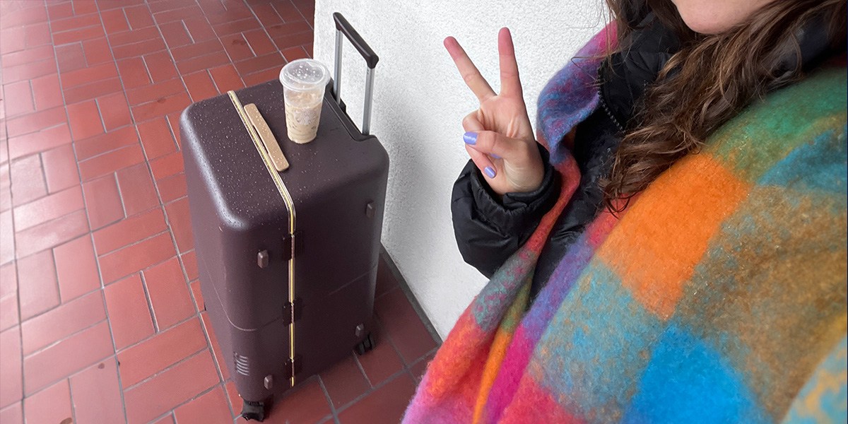 July Checked Trunk up against wall with iced coffee on top  July Checked Trunk up against wall with iced coffee on top