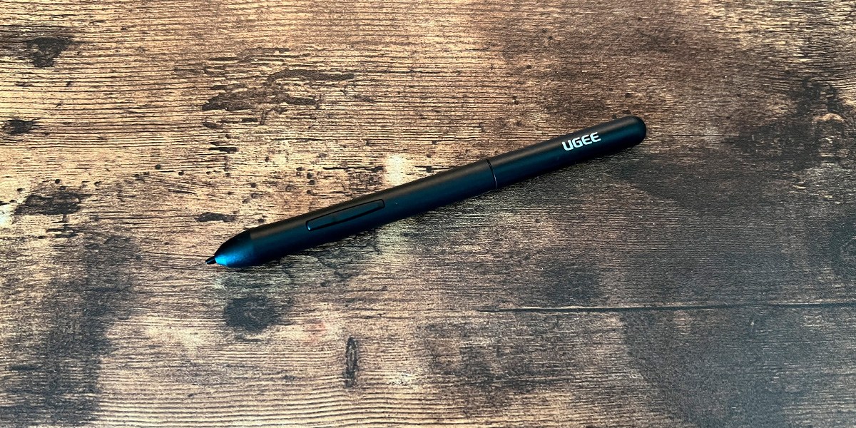 Ugee M708 Graphics Drawing Tablet stylus pen on wooden table Ugee M708 Graphics Drawing Tablet stylus pen on wooden table