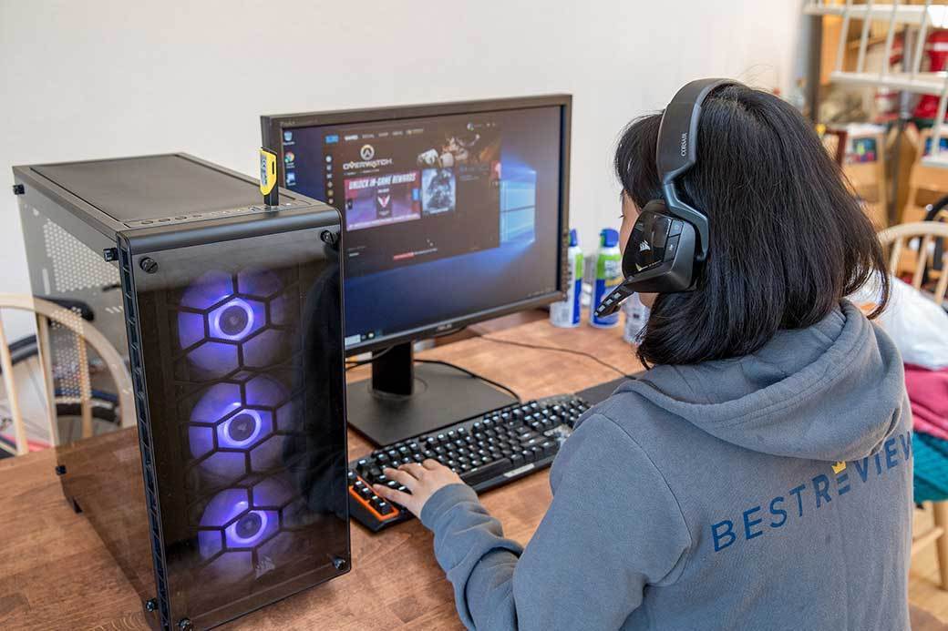 Person playing video games at desk