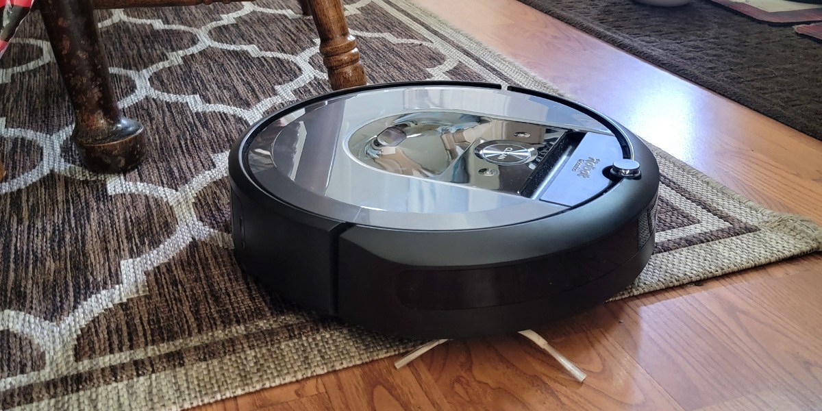 Roomba navigating from carpet onto hard flooring.