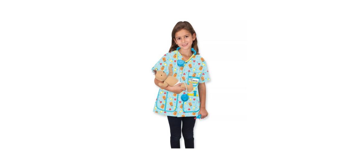 child wearing a pediatric nurse costume, with a baby doll and plastic stethoscope