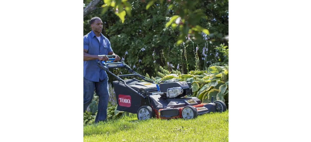Person mowing lawn with Toro TimeMaster Briggs and Stratton Personal Pace Mower