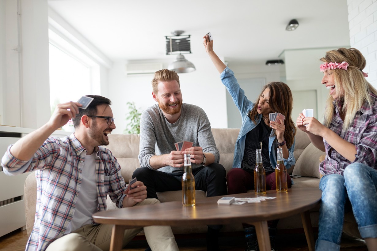 a group of friends playing cards
