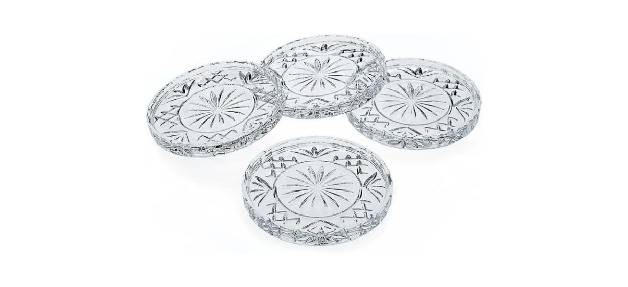 4 crystal coasters with intricate designs on a white background